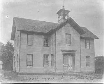 An early black and white photograph of the schoolhouse, captioned “School house at Middlefield” in ink across the bottom